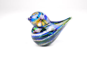 multi-colored glass bird with cremation ash from pets and people