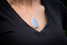 fingerprint engravable blue lace pendant for fingerprints footprints pawprint engraving and more being worn