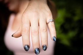 hand with cremation leaf ring being worn by woman