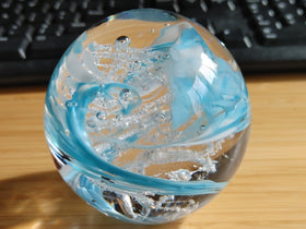 glass orb with ash winter confetti