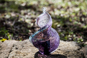 glass sculpture with cremation ash and dichroic glass in purple