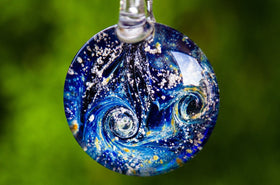 nightswirl glass pendant with cremation ash from pets and people on green background