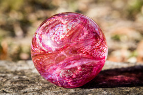 pink glass orb with cremation ash