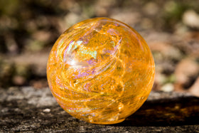 yellow glass orb with cremation ash