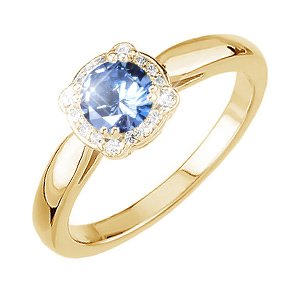 Gold ring with a blue gemstone framed by a halo of small diamonds.