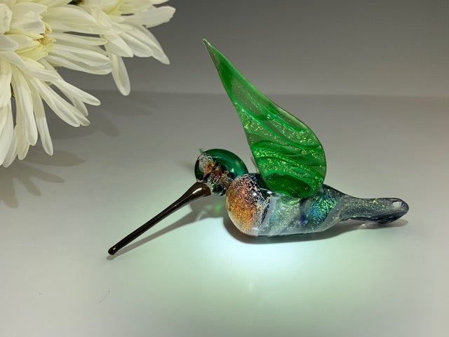Anna's dichroic hummingbird ornament infused with cremation ashes, sparkling body with green wings and a hanging hook.