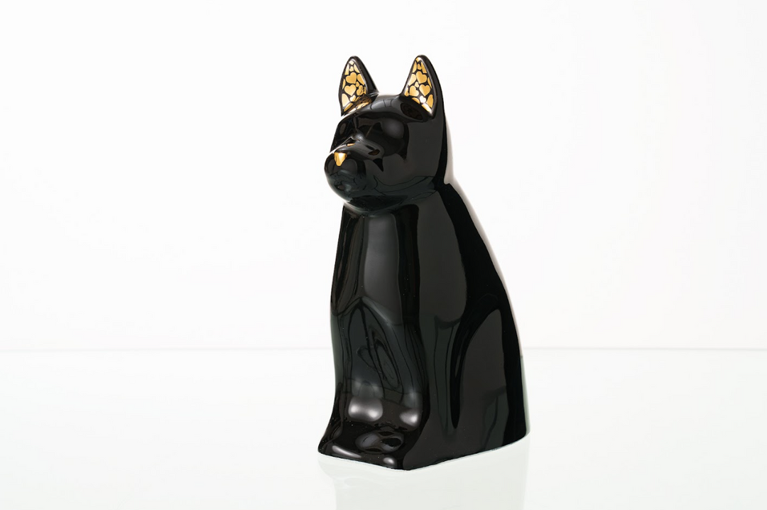 Glossy black Barkley dog ceramic urn with gold paw print accents on the ears.