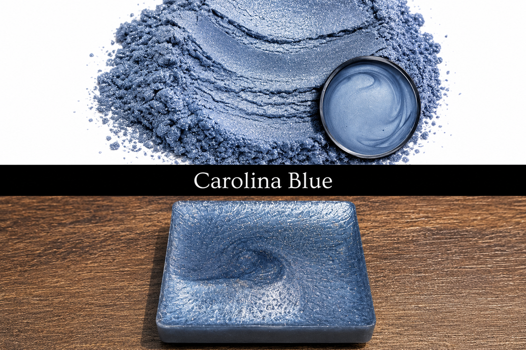 Blue powder with a container and a square dish on a wooden surface, labeled 'Carolina Blue'.
