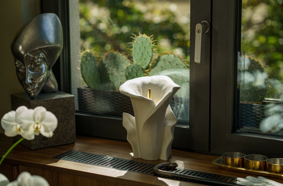 Blue glazed Calla Lily ceramic urn with sculpted petals and a gold stem, bottom filled.