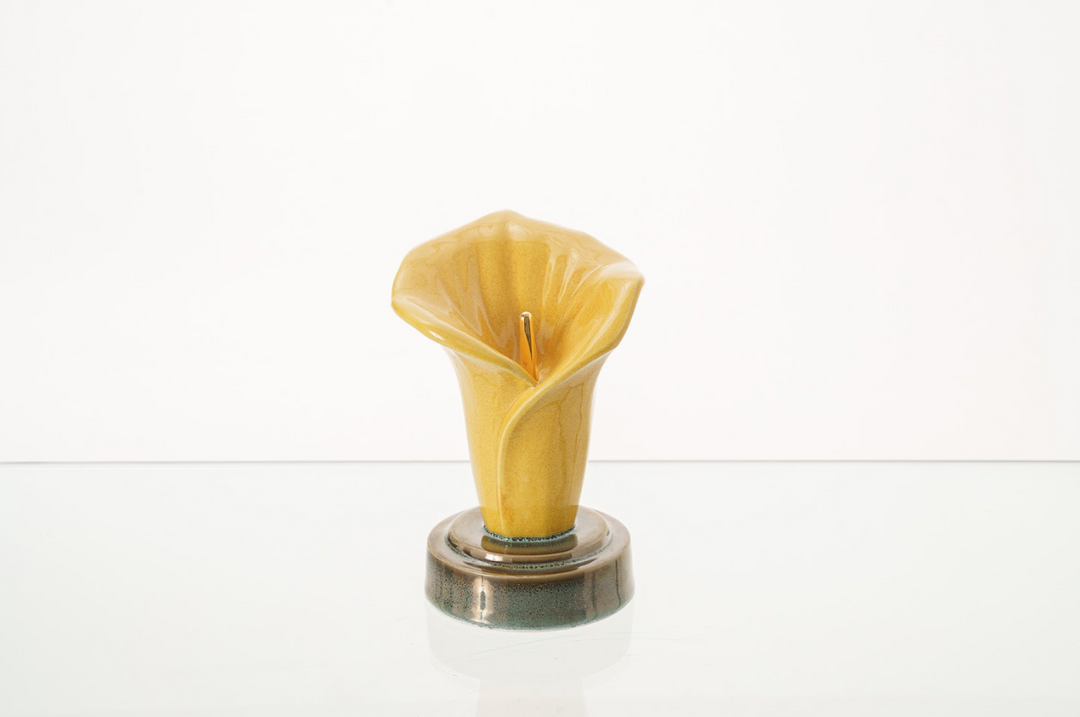 Yellow Calla Lily Keepsake Ceramic Urn on a round glaze base, bottom filled.
