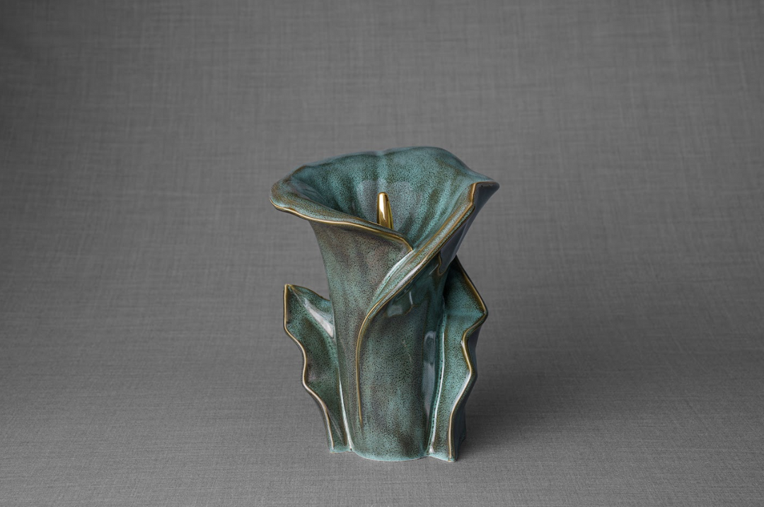 Turquoise Calla Lily ceramic urn with gold trim, front view against a gray backdrop.
