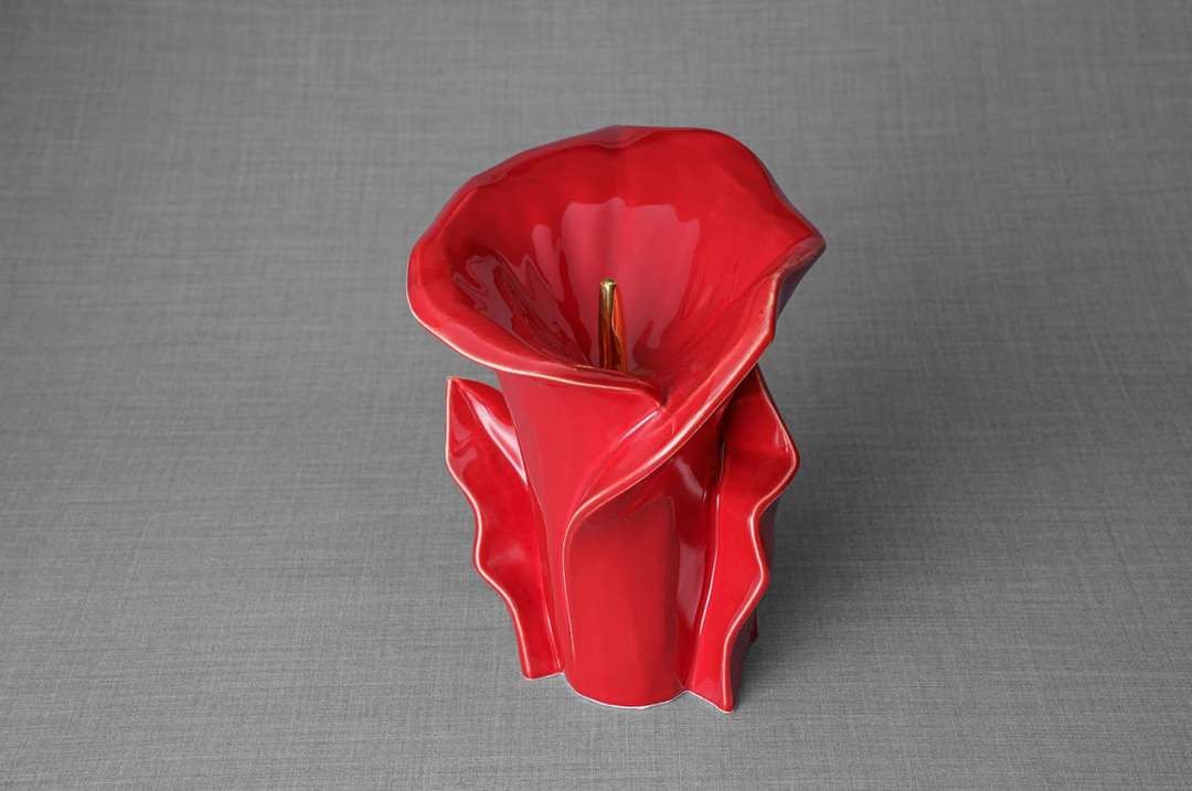 Glossy red Calla Lily ceramic memorial urn with sculpted petals and a gold stem.