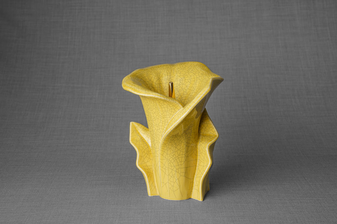 Yellow crackle glaze Calla Lily ceramic memorial urn shown from the side with curved petal details.