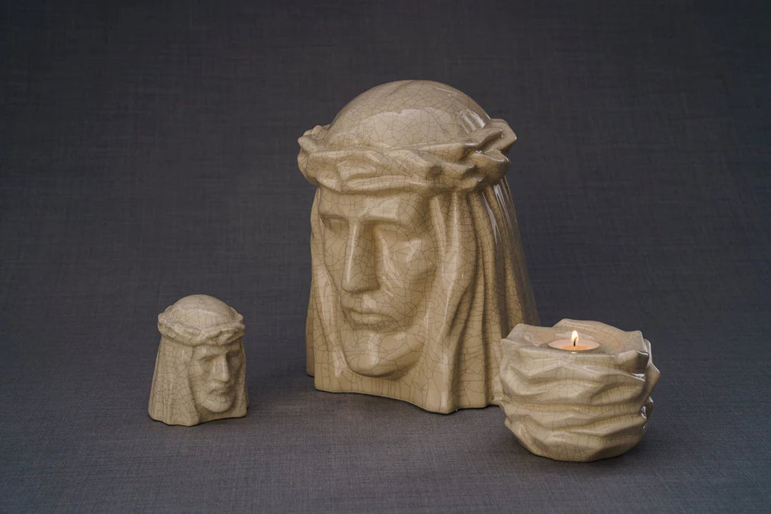 Beige crackle glaze Christ bust with crown of thorns accompanied by a small vessel and a candle holder