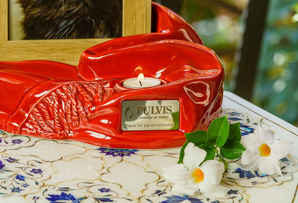 Cozy ceramic urn in red glaze with a built in candle and a wooden picture frame for personalization.