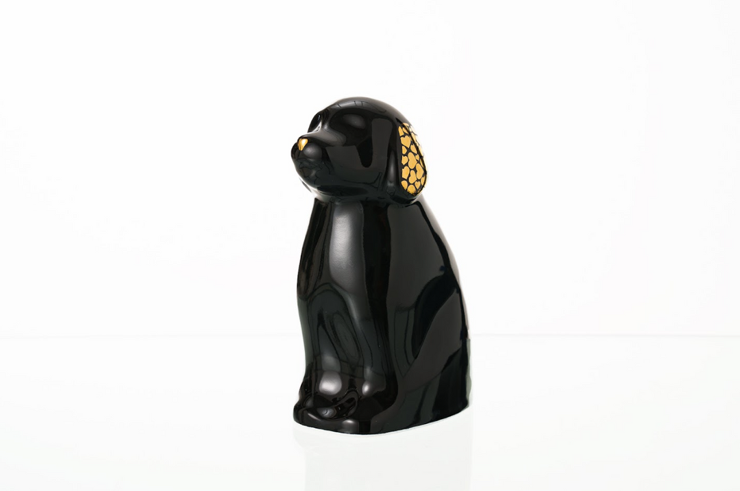 Glossy black dog shaped ceramic urn with gold patterned ears