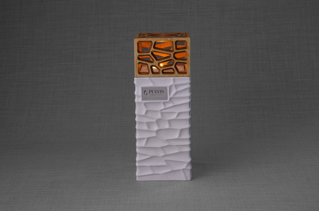White textured base Everlasting Flame urn with a brown lattice top and a lit candle.