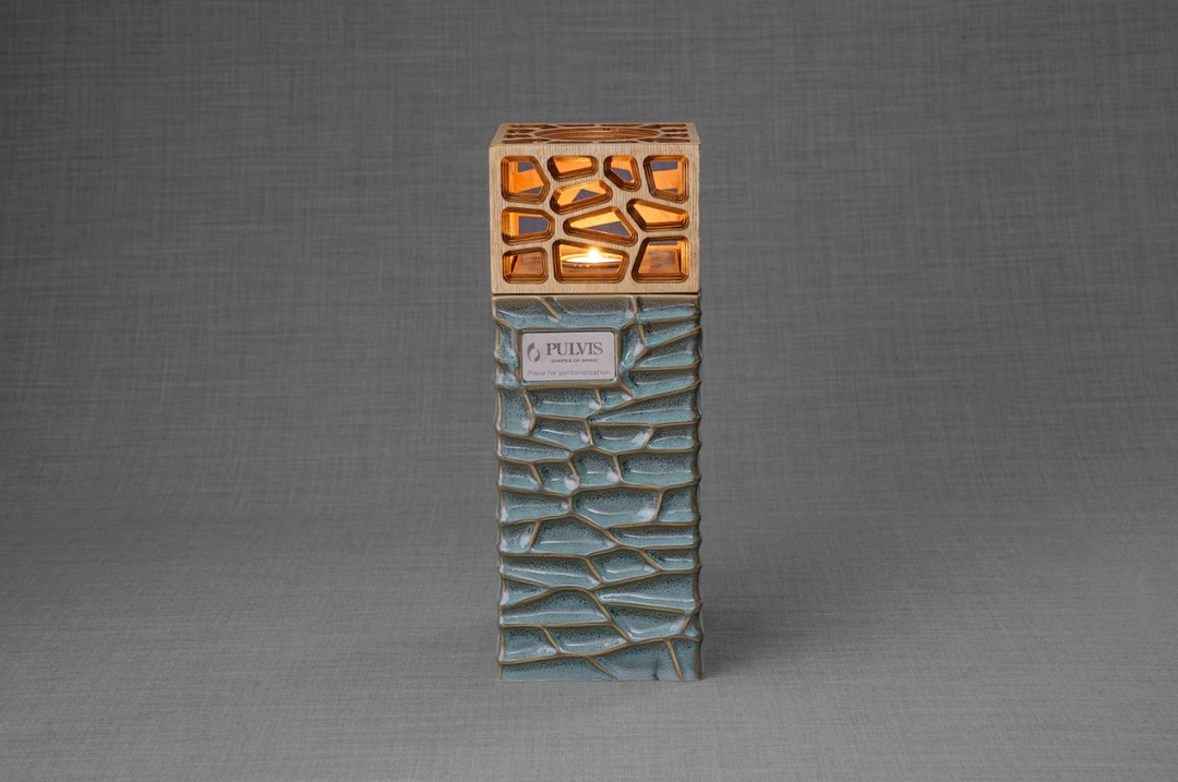Everlasting Flame ceramic urn with teal crackle base and warm wood lattice crown around a glowing candle.