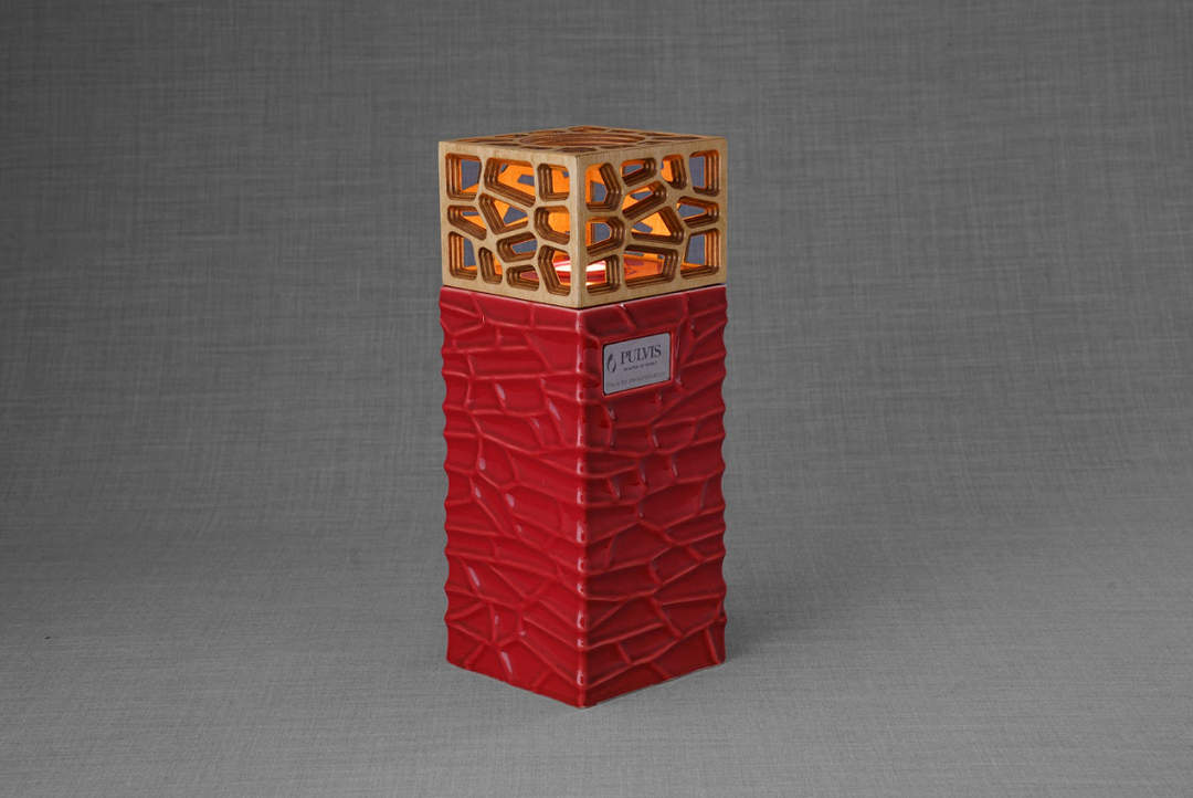 Everlasting Flame ceramic urn with beige crackle base and gold lattice top surrounding a lit candle.