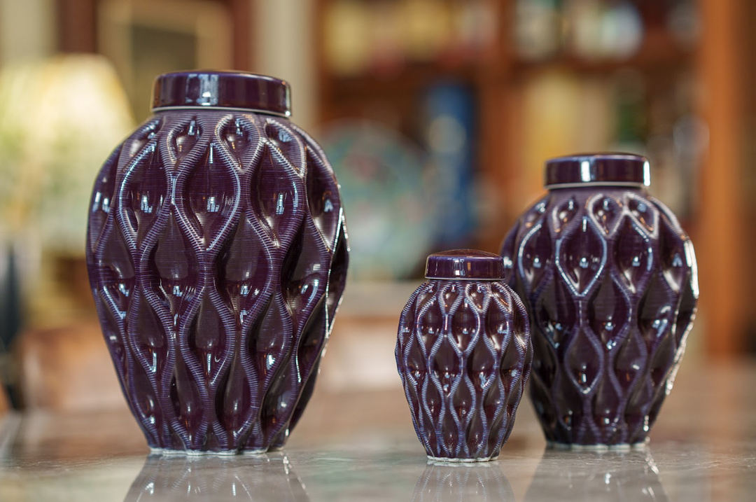 Six decorative ceramic urns with lids in purple beige yellow green tan and blue featuring a raised lattice pattern on a reflective surface