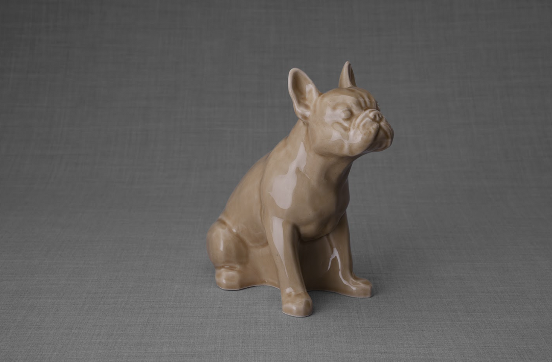 Beige ceramic French Bulldog sculpture on a gray backdrop