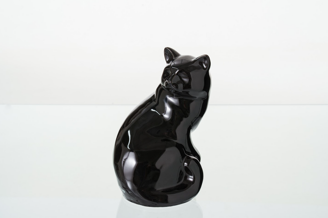 Glossy black Felix cat ceramic urn shown in a seated side profile