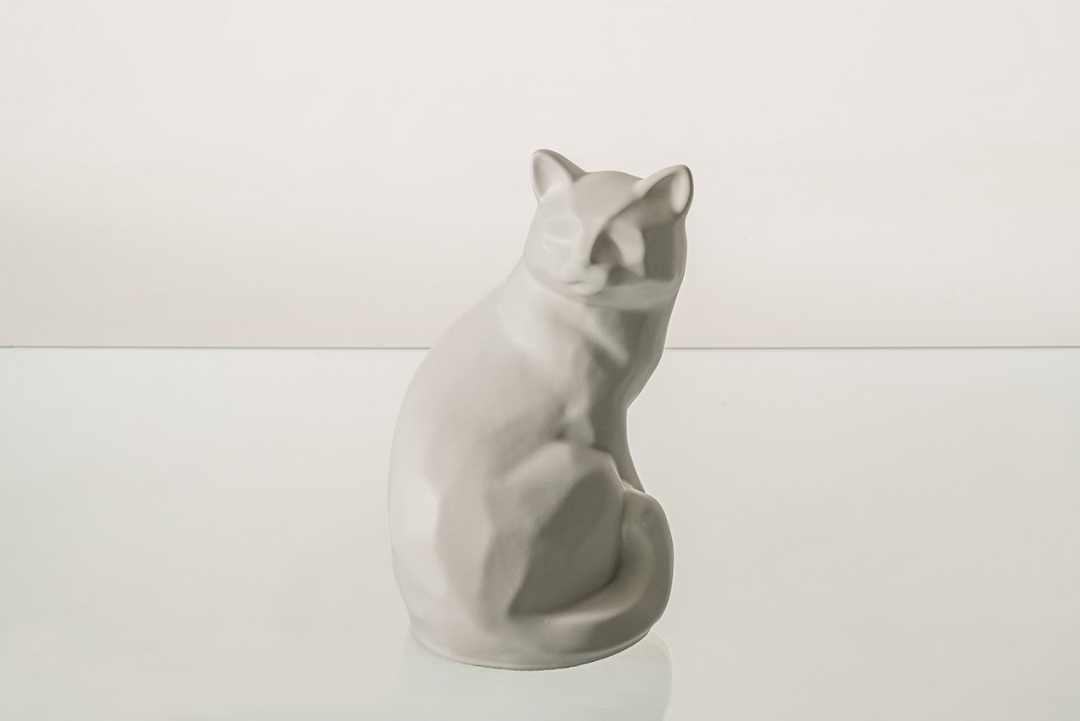 Felix cat urn in pale gray ceramic with a smooth minimalist silhouette.