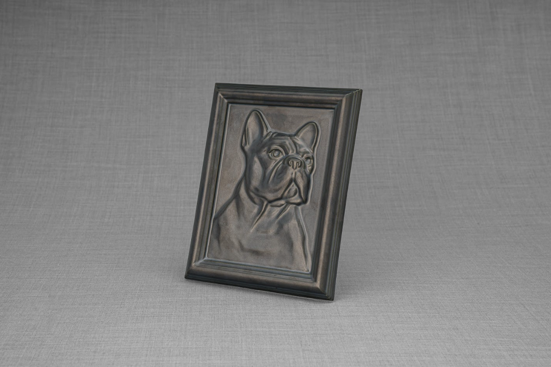 Angled view of a black framed French bulldog relief from the Frenchie Frame Ceramic Urn