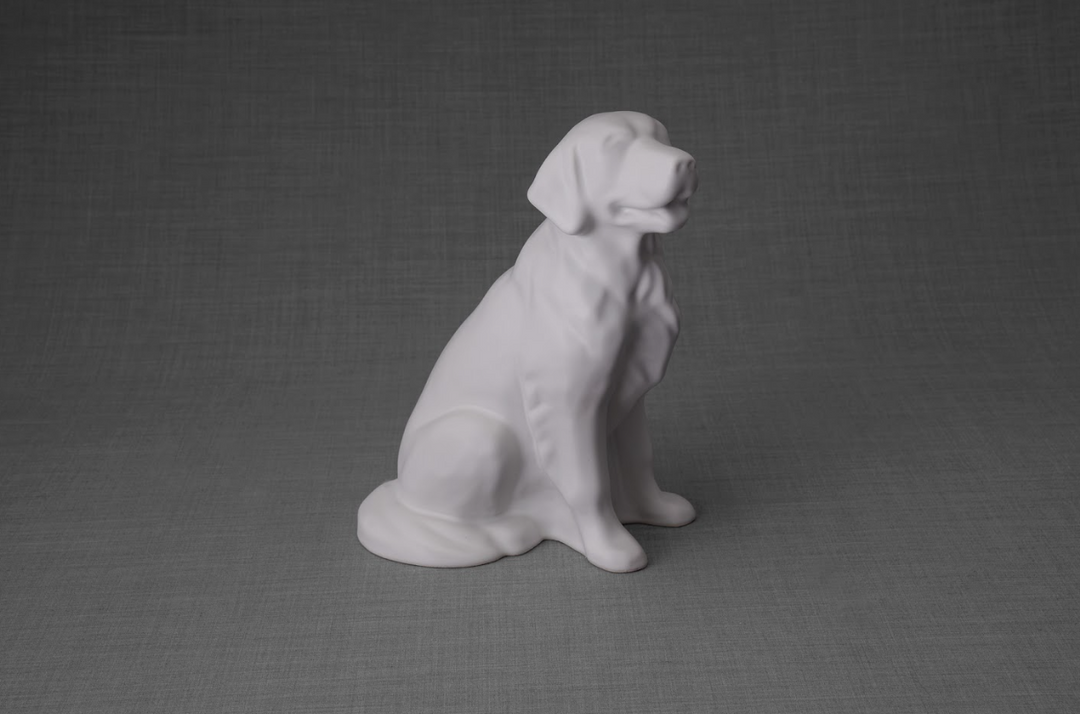 White ceramic Golden Retriever figurine sitting against a gray backdrop