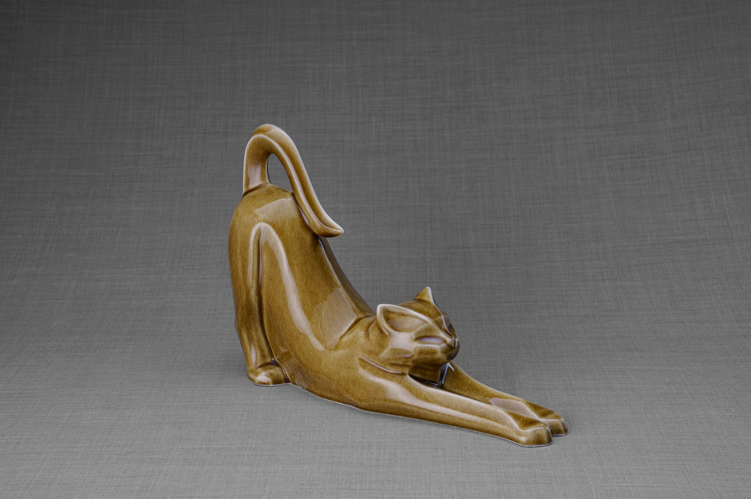 Grace Cat Ceramic Urn in warm brown glaze showing a stretching cat with a curved tail.