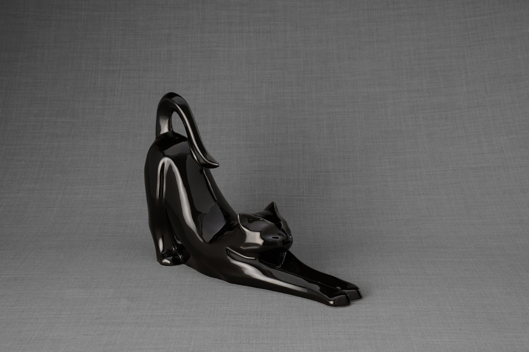 Grace Cat Ceramic Urn in glossy black glaze featuring a stretching cat and arched tail.