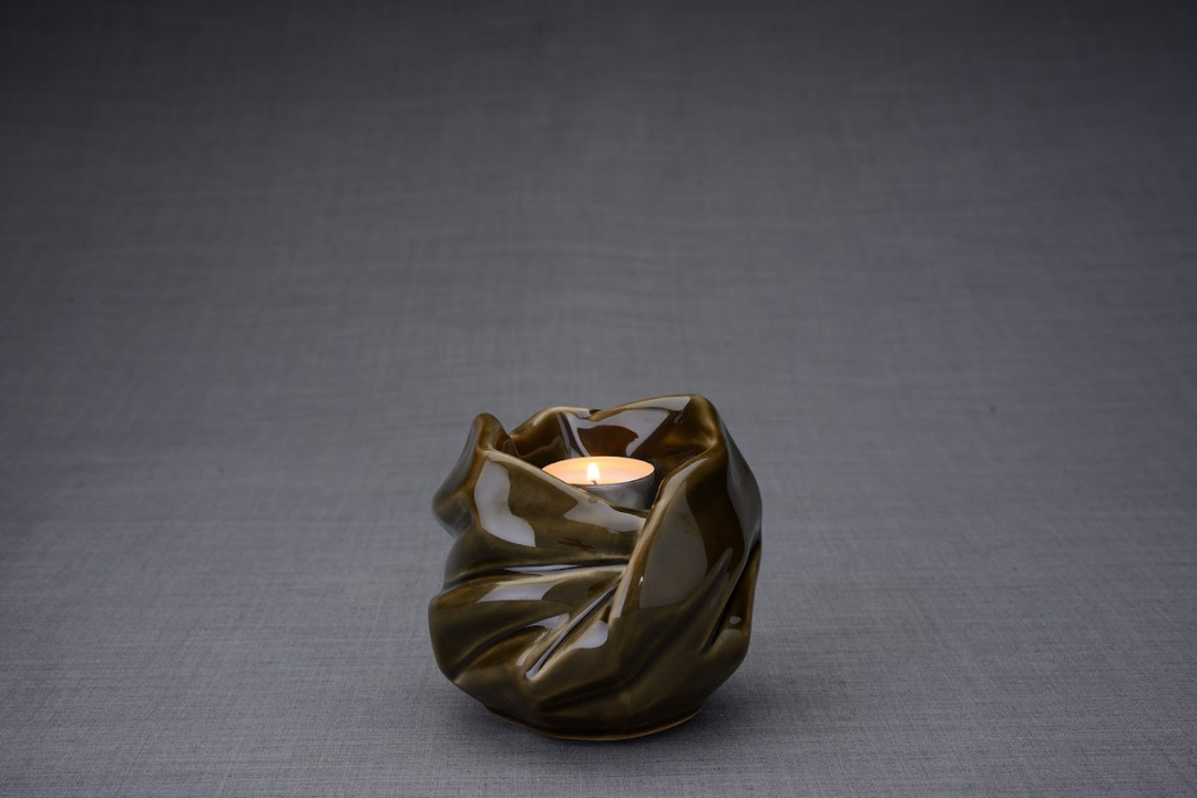 Olive brown glazed Holy Mother ceramic urn with a lit candle in the opening