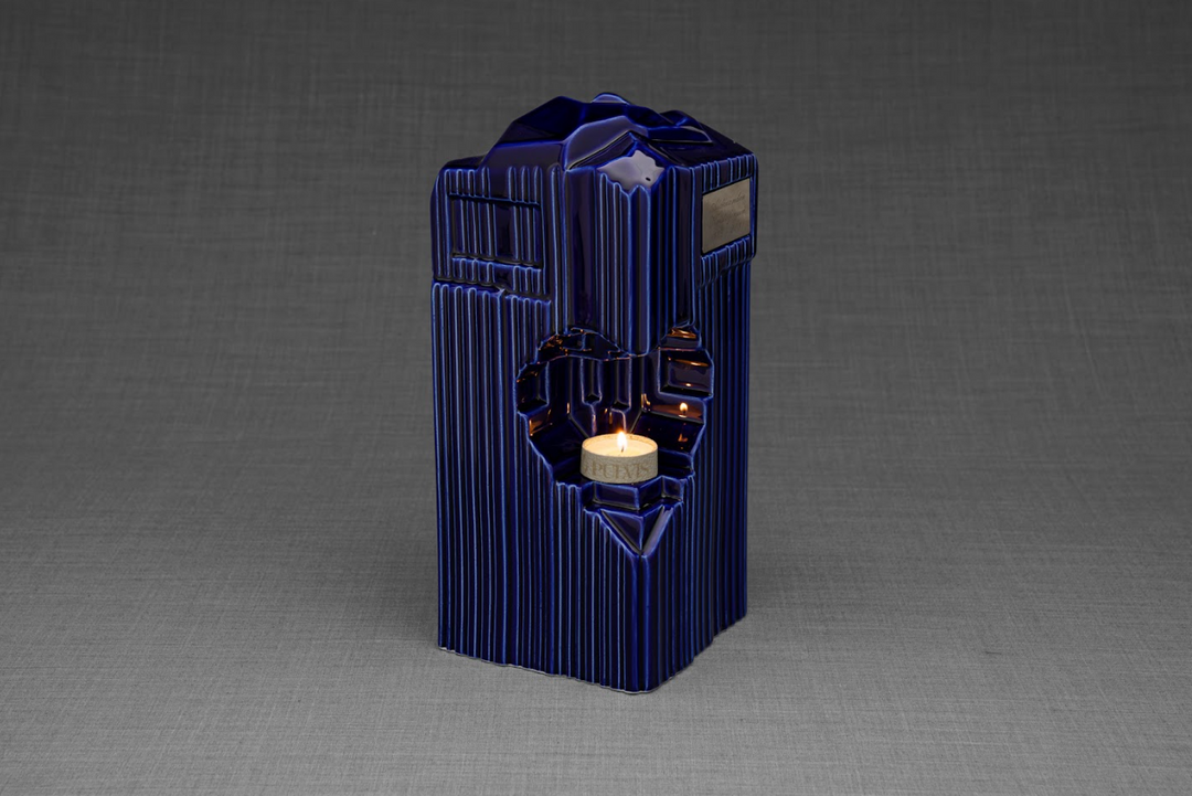 Blue Heart Ceramic Urn with candle holder and heart cutout, holding a lit tealight