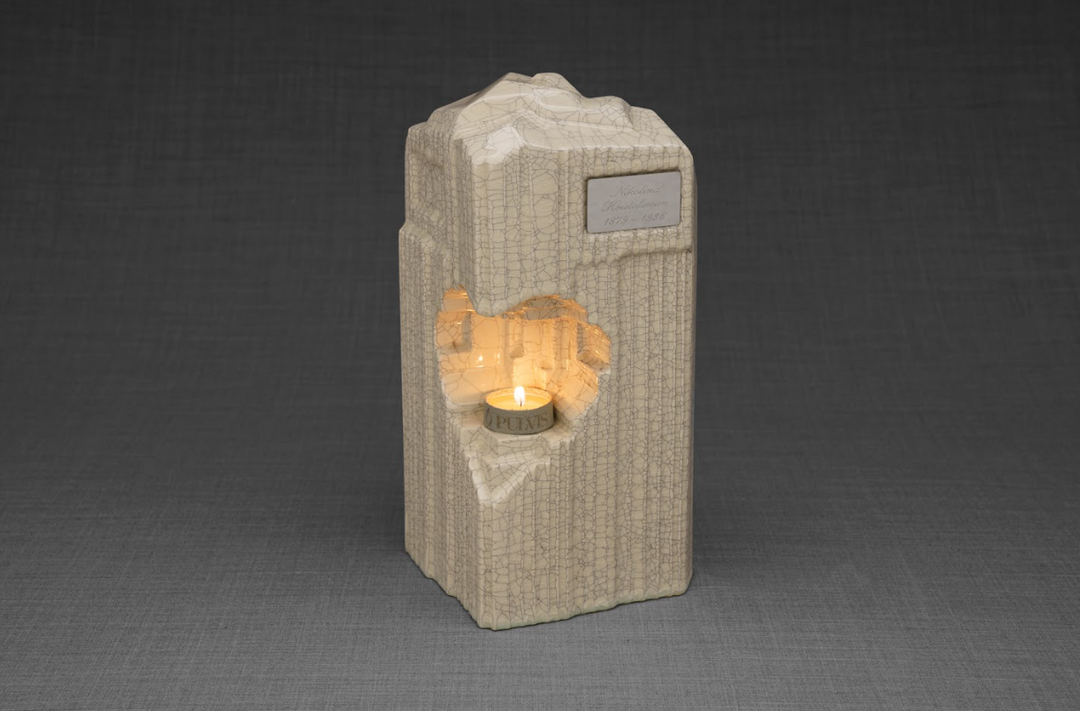 Beige crackled ceramic upright urn with an engraved plaque and a heart shaped candle niche in front.