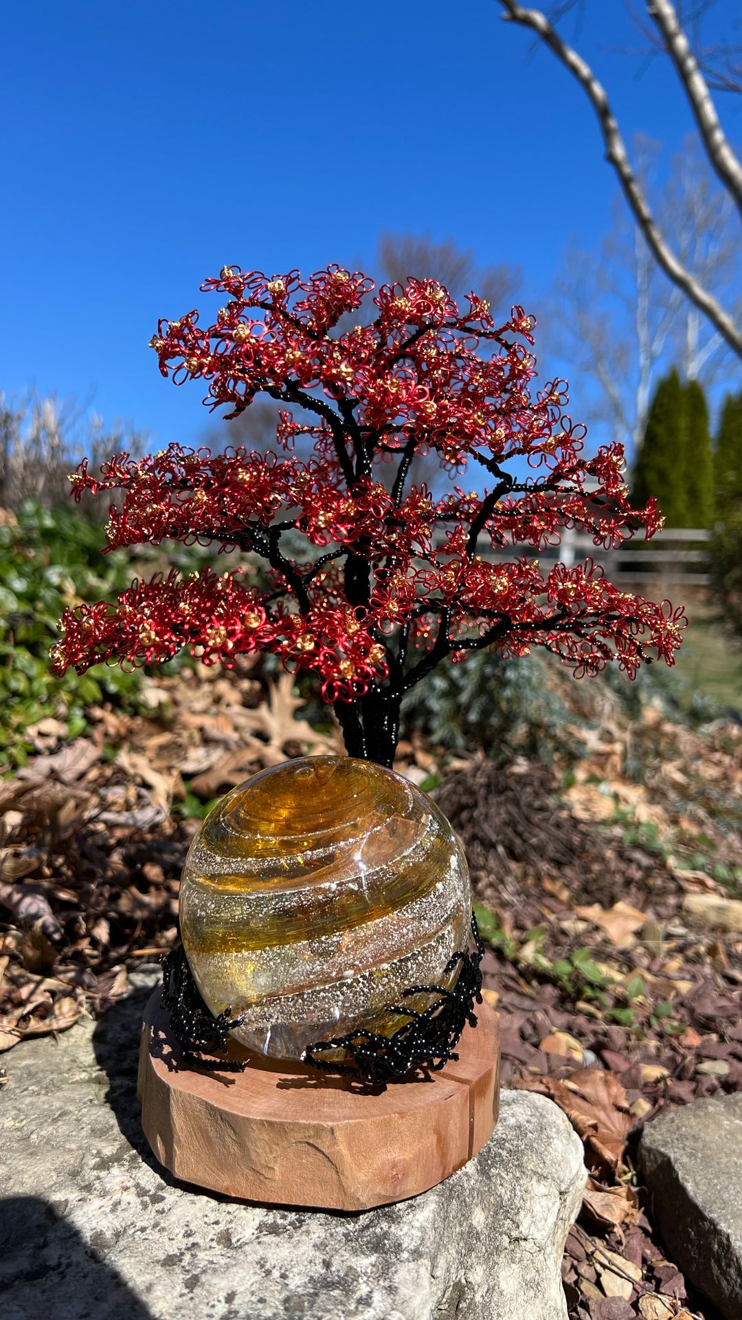 Flamboyant Tree of Life wire tree with red and gold blossoms atop a 3 inch amber Sparkle Orb on a wooden base.