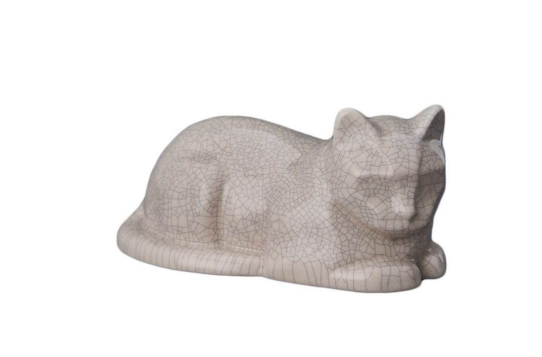 Side profile of a beige cat ceramic urn with pronounced crackle glaze