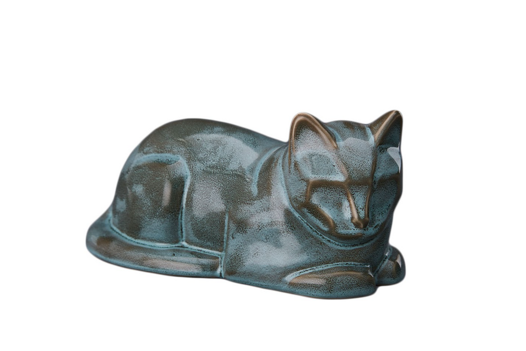 Blue green glazed laying cat ceramic urn in a peaceful sleeping pose