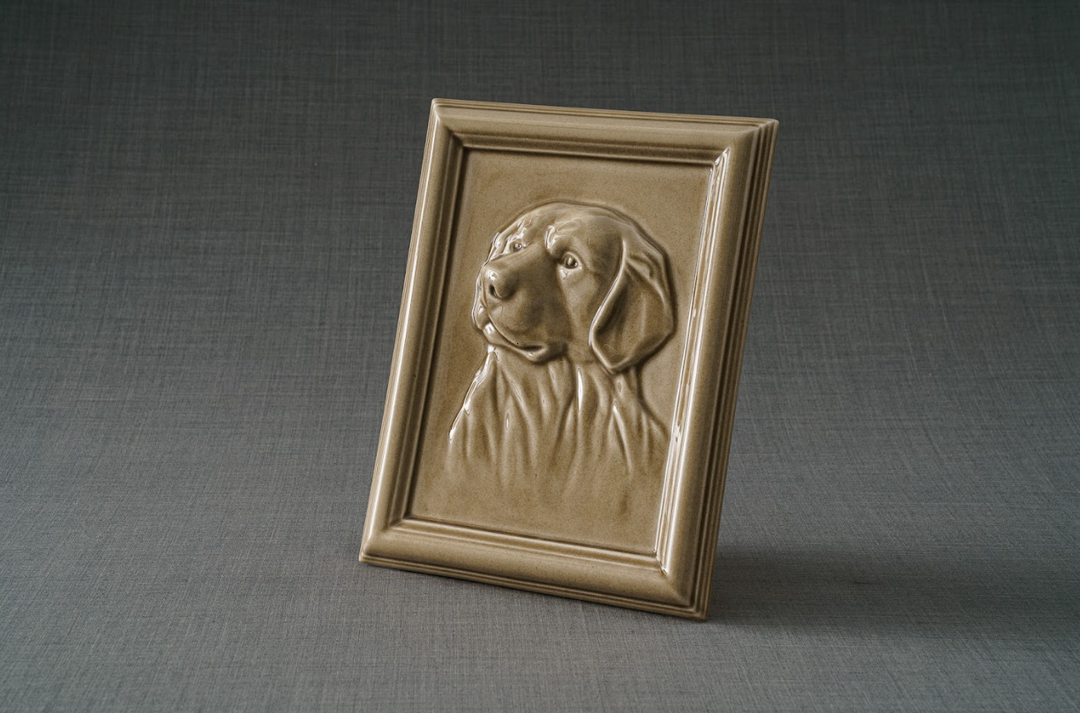 Gold Labrador portrait ceramic frame shown at an angle on a gray fabric backdrop.