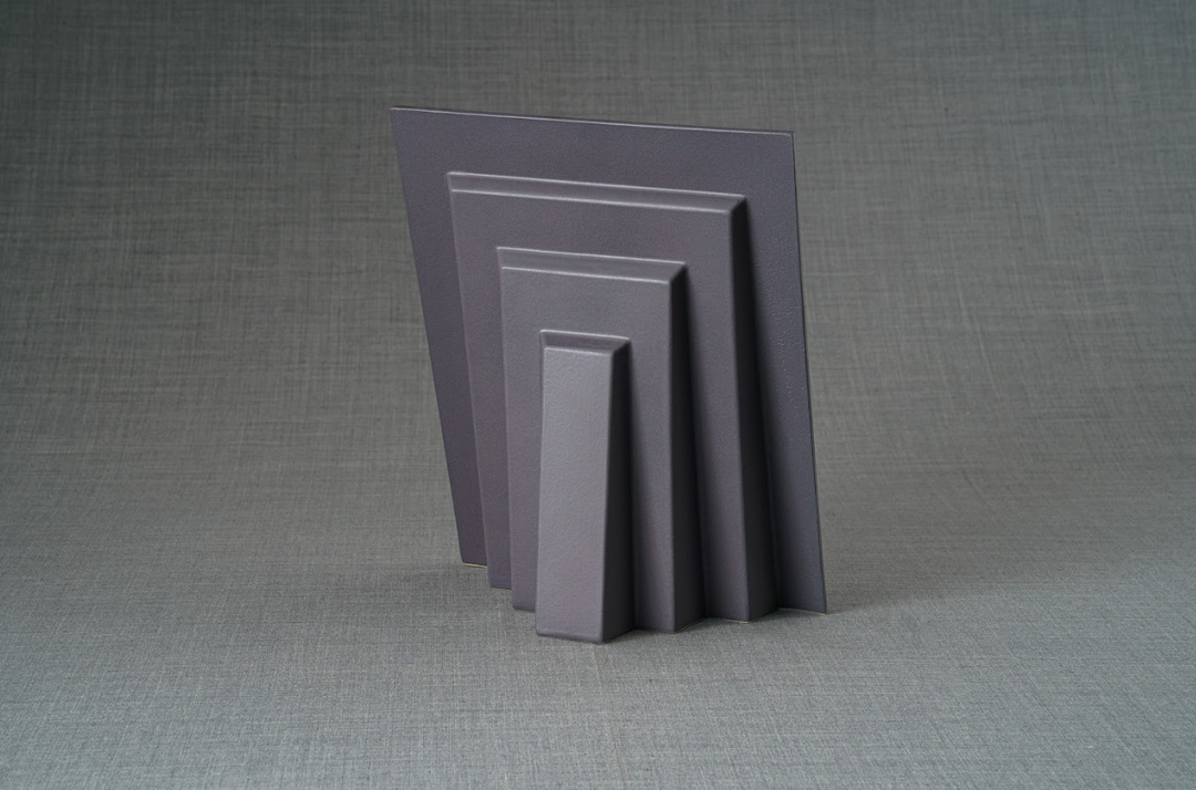 Dark gray ceramic rectangular frames arranged in a stepped display, part of the Labrador Frame set
