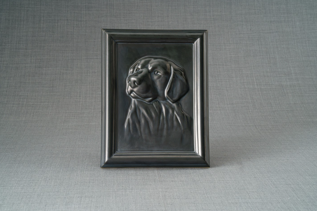 Dark metal frame featuring a Labrador portrait relief against a gray backdrop.