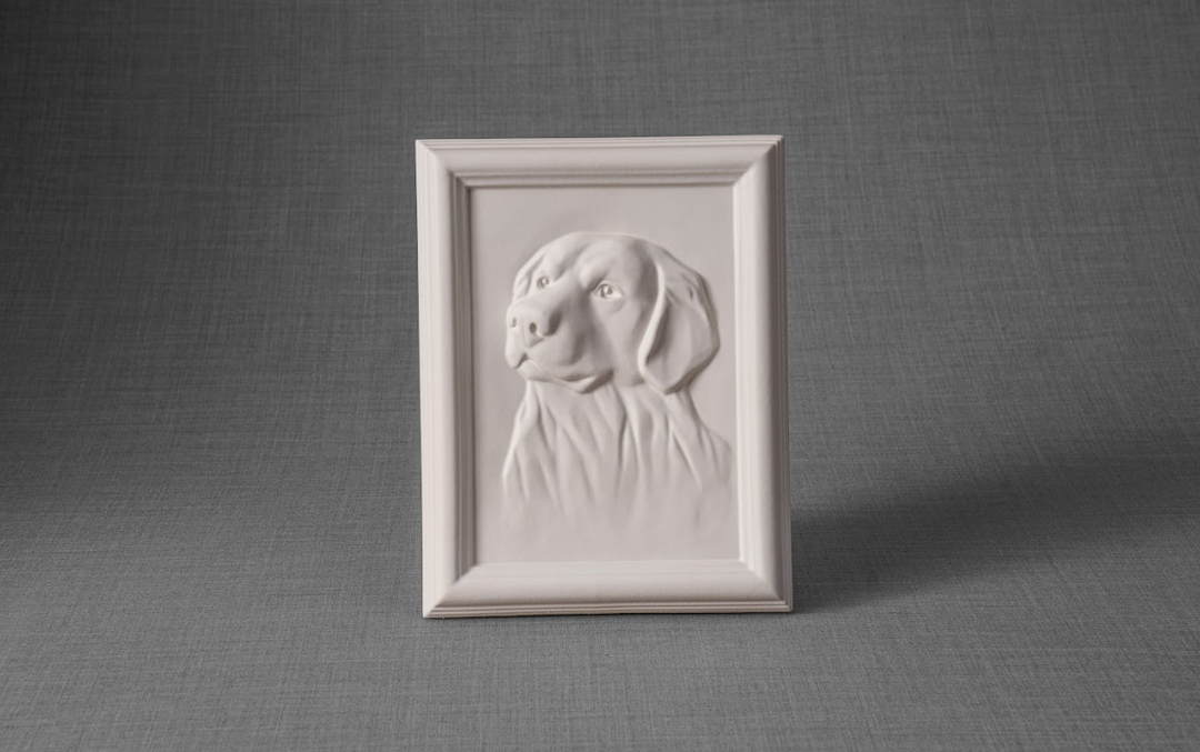 White framed Labrador portrait ceramic urn on a gray textured surface.
