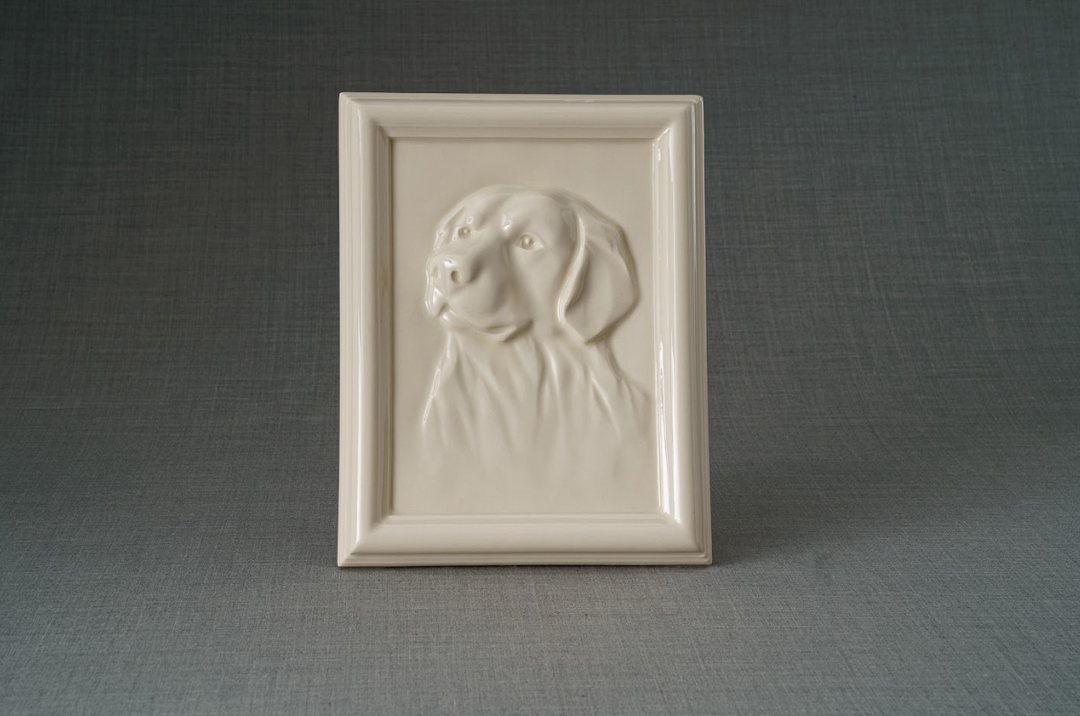 Cream framed ceramic urn with a raised Labrador head relief.