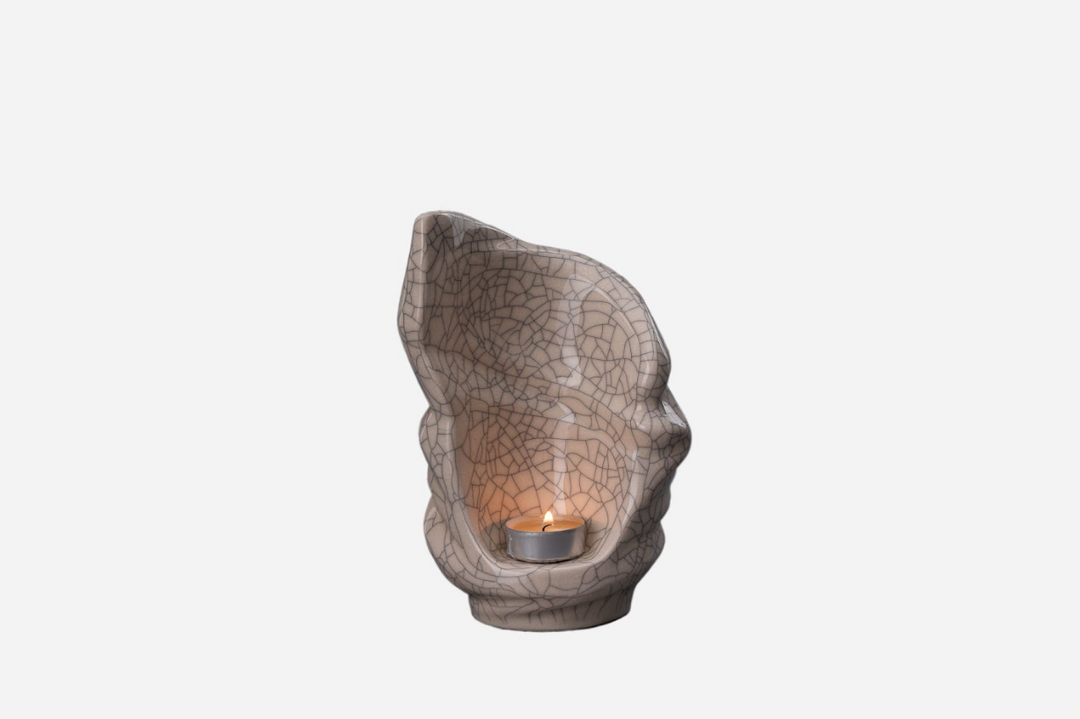 Beige crackle glaze Light Ceramic Urn with an inner cavity and a lit tealight inside.
