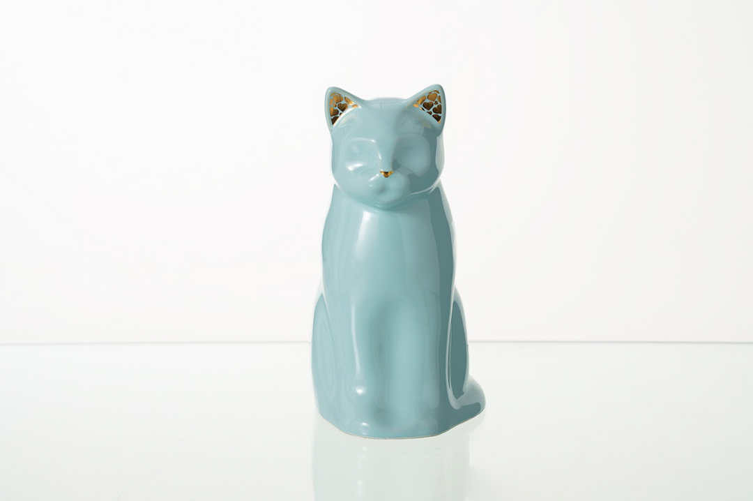 Meow cat ceramic urn in soft baby blue glaze with a calm minimalist feline form.