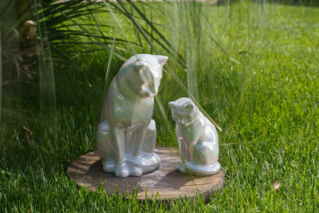 Ceramic Neko Cat urn sculpture with a larger cat and a kitten on a round base outdoors.