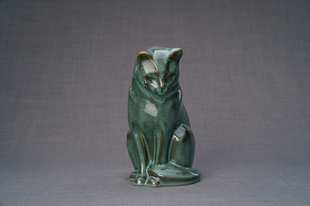 Green glazed ceramic cat urn in a seated pose with a glossy finish