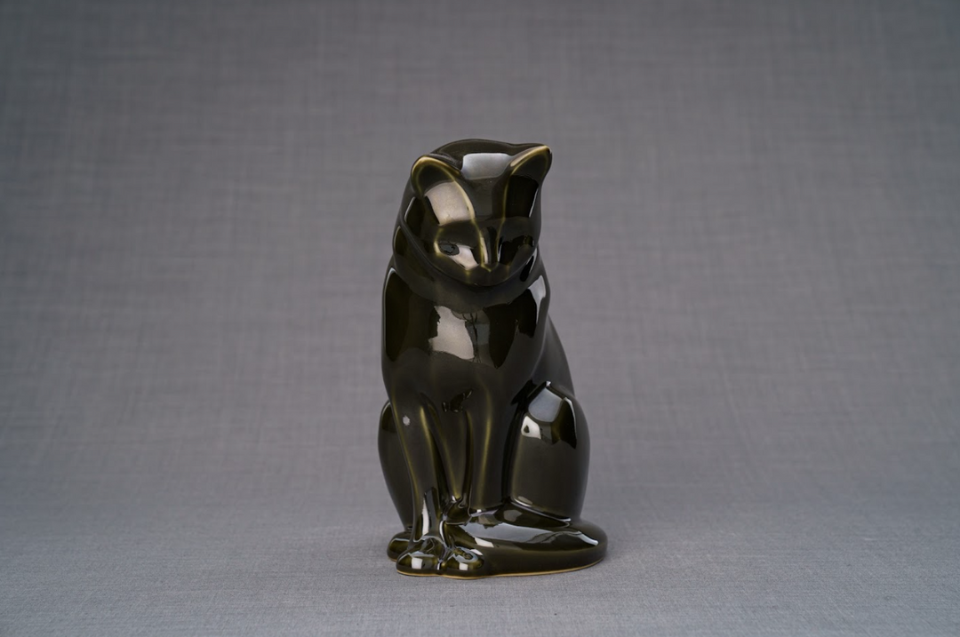 Glossy black ceramic cat urn in a seated pose with subtle gold highlights