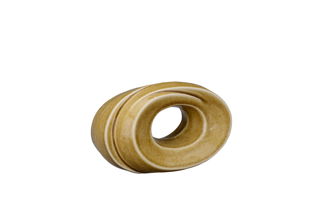 Golden brown ceramic urn with looping rings and a central hollow, shown tilted to highlight its sculptural form.