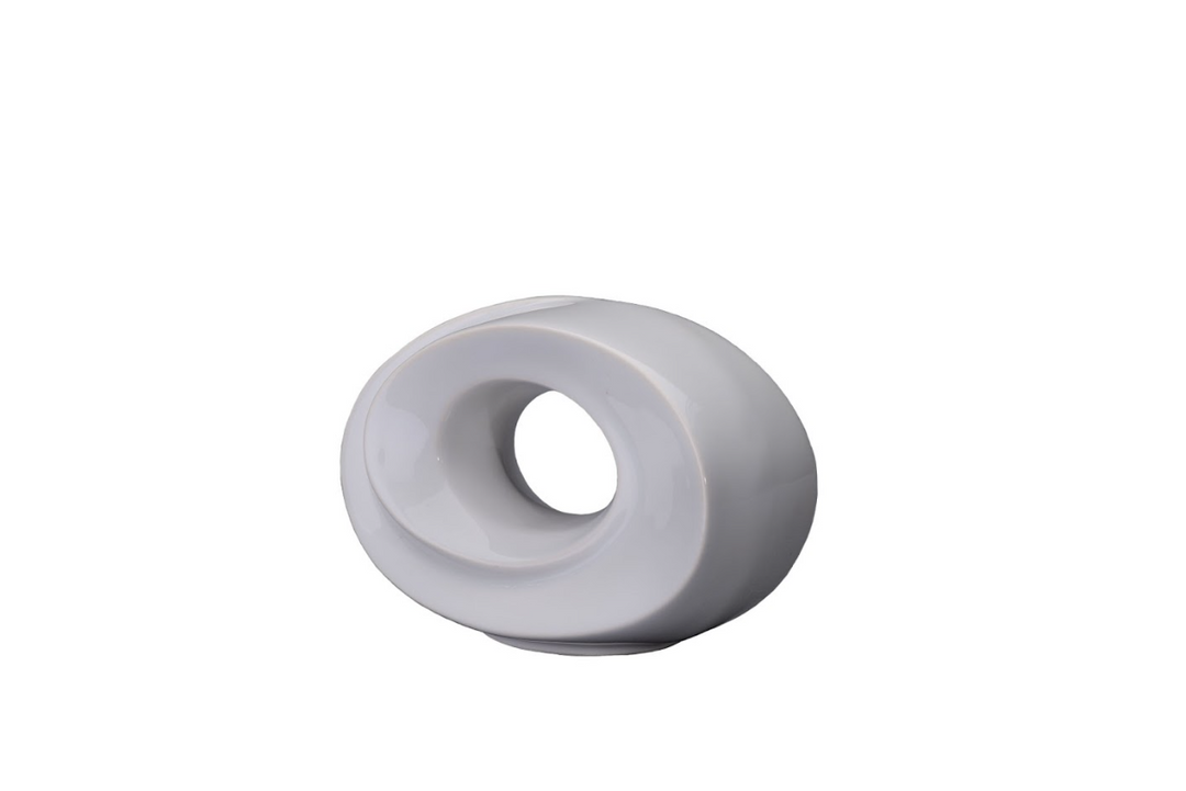 The Passage Ceramic Urn in white ceramic with a torus shape and hollow center.