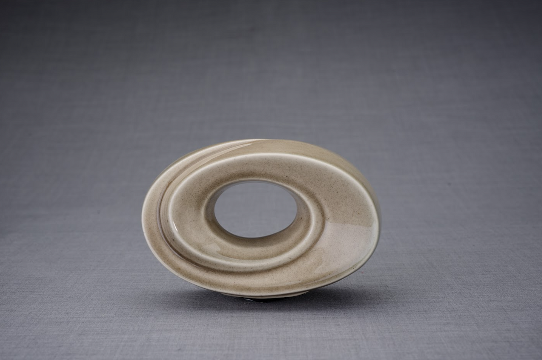 Beige ceramic urn with a smooth circular hollow center and flowing spiral rings for display.